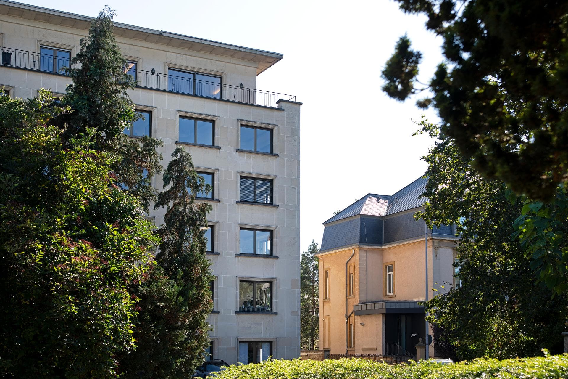Modern buildings in Luxembourg surrounded by green trees